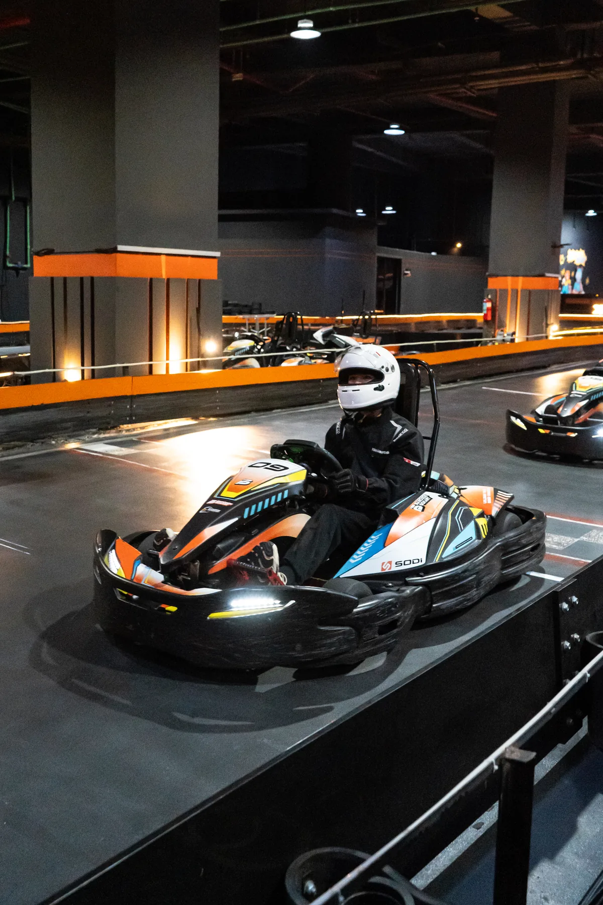 Faith driving an electric SODI kart on the indoor Barcode Gokart circuit