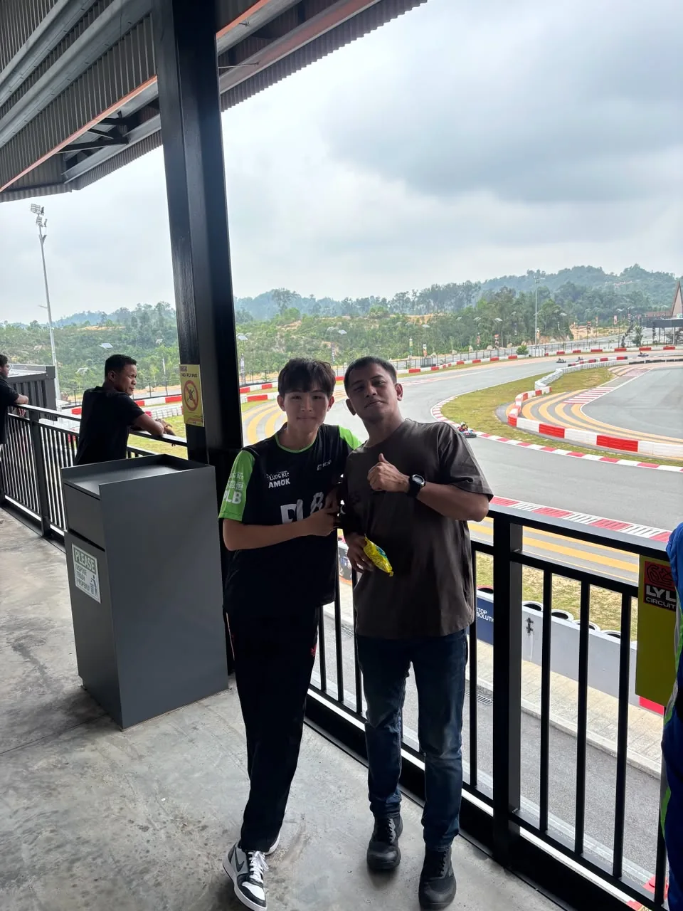 Faith with his coach overlooking the LYL International Karting Circuit
