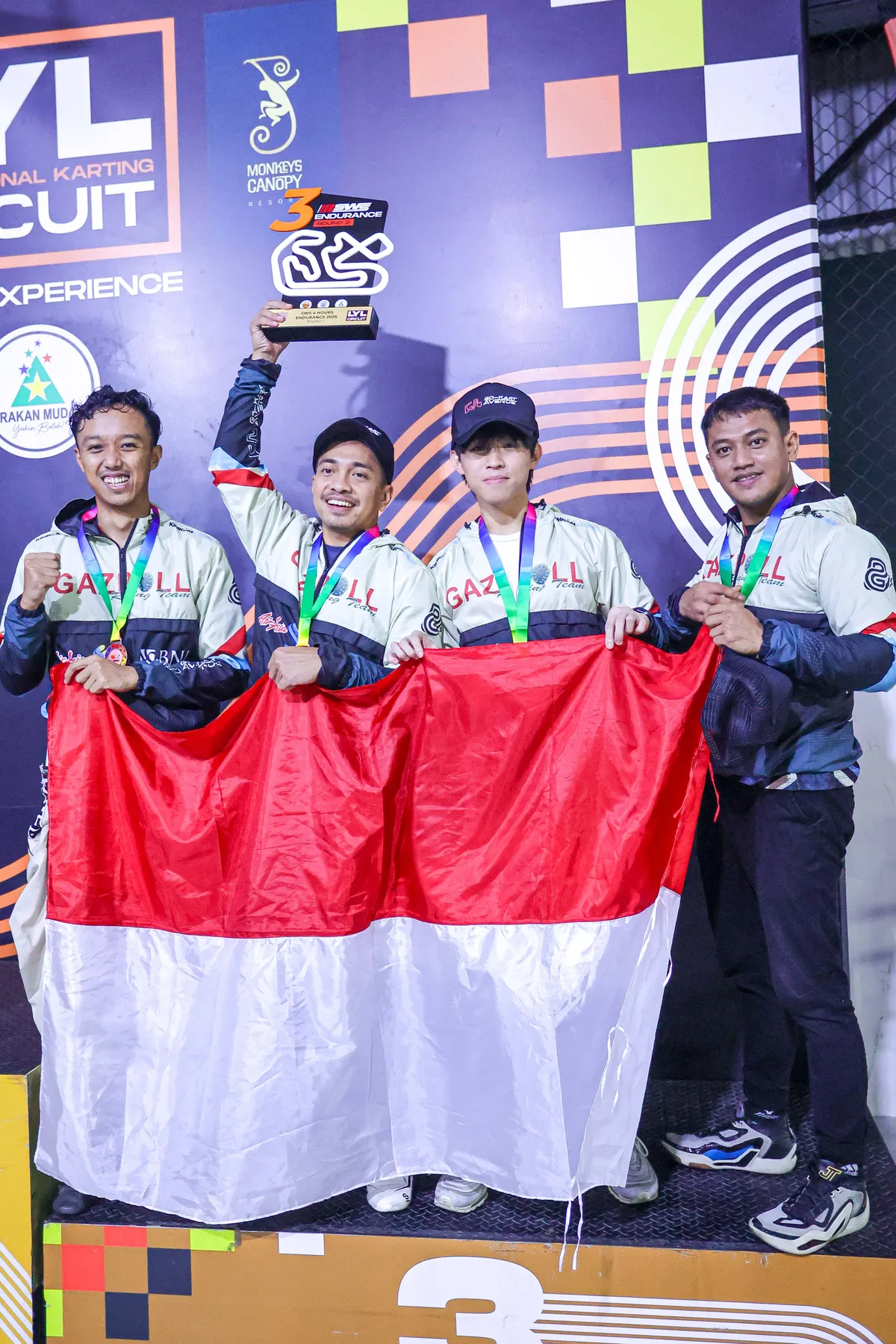 Podium finish with Gazpoll Racing Team, holding the Indonesian flag